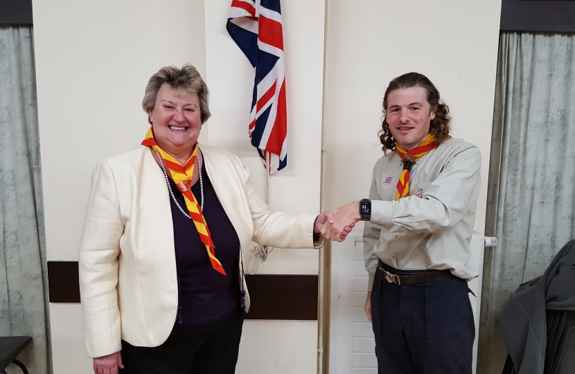 Heather Wheeler MP being instilled as an Honourary Scout in the 1st Hartshorne Group by Leader, Tim Moore, at Goseley Community Centre