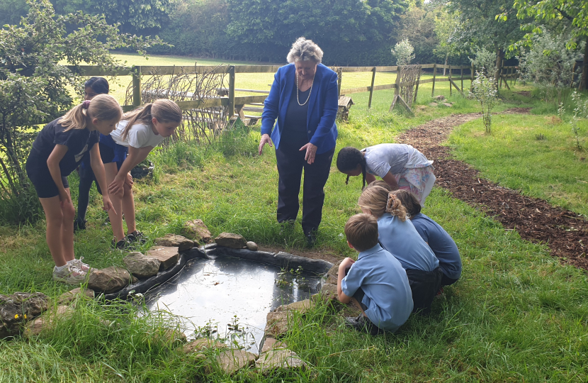 Eco Committee Team Members with Heather looking at the newly built pond. They are eagerly awaiting the arrival of frogs and newts!