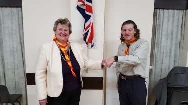 Heather Wheeler MP being instilled as an Honourary Scout in the 1st Hartshorne Group by Leader, Tim Moore, at Goseley Community Centre